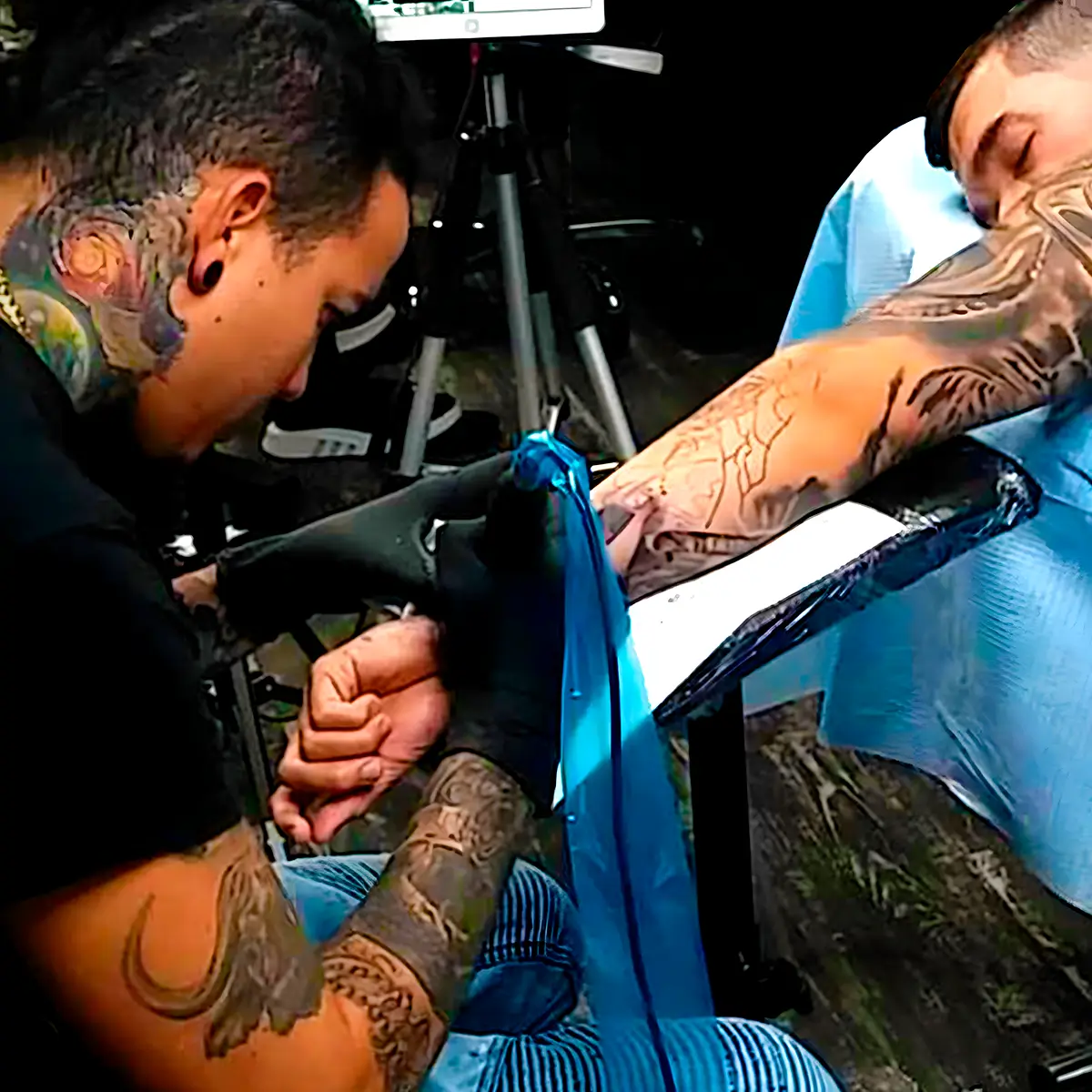 Alex Chiong working on a custom arm tattoo at Alex Chiong Tattoo Studio in North Miami.